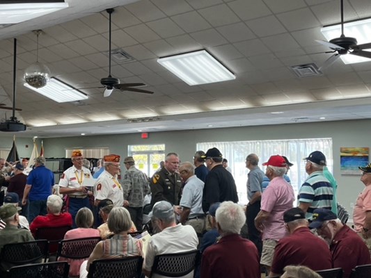 VWC's Col. Cramer pins a Vietnam veteran.