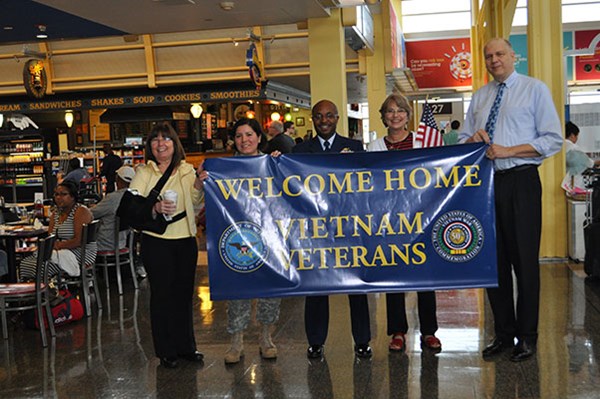 Greeters await visiting Vietnam Veterans arriving on an Honor Flight sponsored by Old Glory Honor Fl
