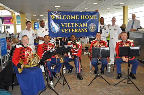 Servicemembers await visiting Vietnam Veterans arriving on an Honor Flight sponsored by Old Glory Ho