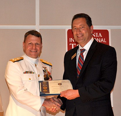 Adm.Gortney, Commander, U.S. Fleet Forces presents Virginia International Tattoo with certificate.