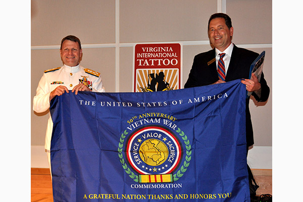 Adm.Gortney, Commander, U.S. Fleet Forces presents Virginia International Tattoo with certificate.
