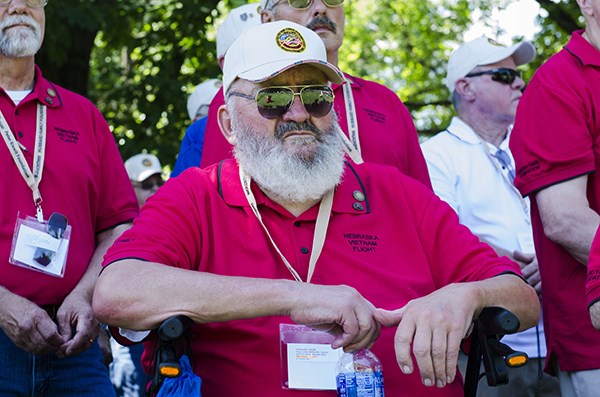 Vietnam veteran listens during a ceremony commemorating Nebraska Honor Flight participants.