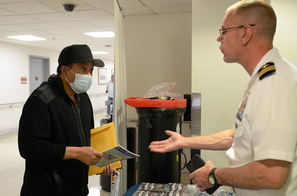 CDR Brian Wierfzbicki greets a Vietnam veteran at the display table.