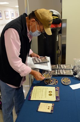 A Vietnam veteran looks at information materials on the VWC display table. 