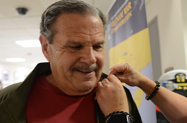 A VWC staff member pins a VVLP on a Vietnam veteran.