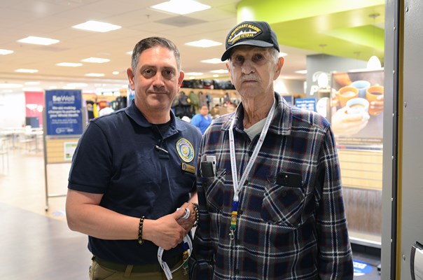 The Vietnam veteran owner of the store inside the center, poses with VWC staff. 