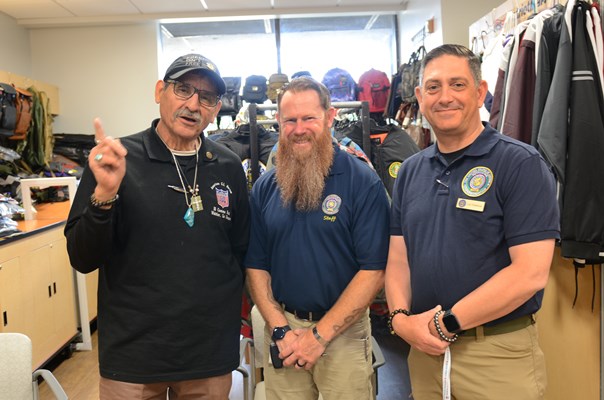 A Vietnam veteran poses for a photo with VWC staff members.