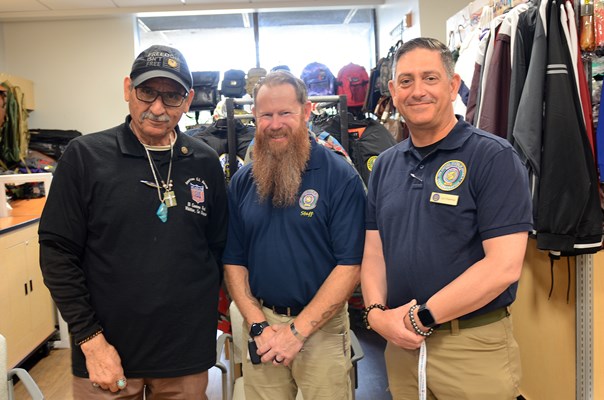 The Vietnam veteran owner of the store inside the center, poses with VWC staff. 