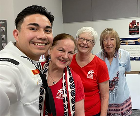Petty Officer 2nd Class Romero with DAR chapter members.