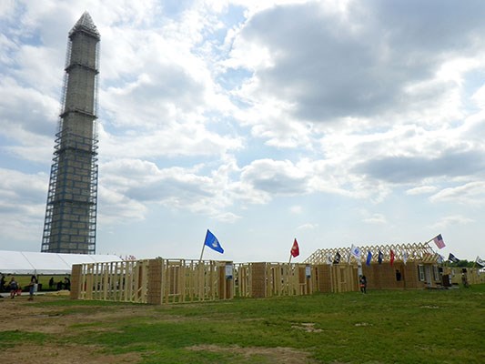 AmeriCorps members, veterans and civilian volunteers form seven houses at the Mall in Washington, D.