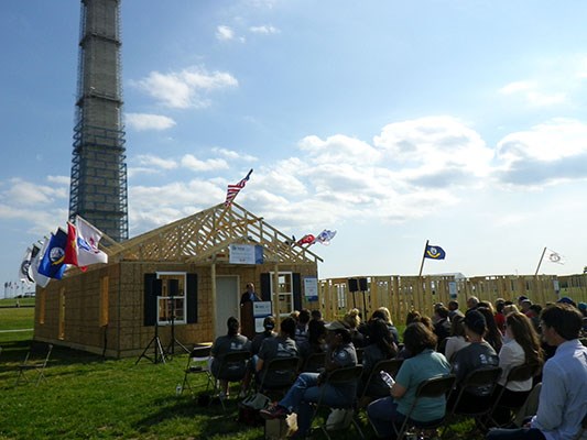 AmeriCorps members, veterans and civilian volunteers form seven houses at the Mall in Washington, D.