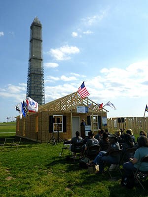 AmeriCorps members, veterans and civilian volunteers form seven houses at the Mall in Washington, D.