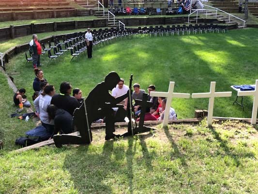 Flag-raising in honor of fallen heroes in a outdoor amphitheater in the Menominee Nation.