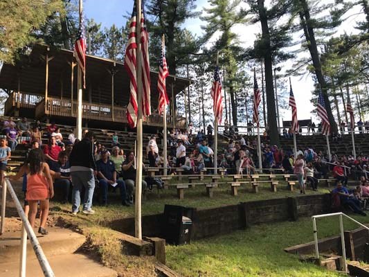 Flag-raising in honor of fallen heroes in a outdoor amphitheater in the Menominee Nation.