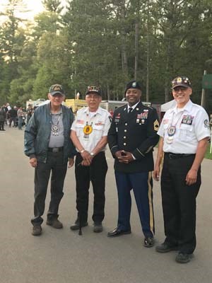 Flag-raising in honor of fallen heroes in a outdoor amphitheater in the Menominee Nation.