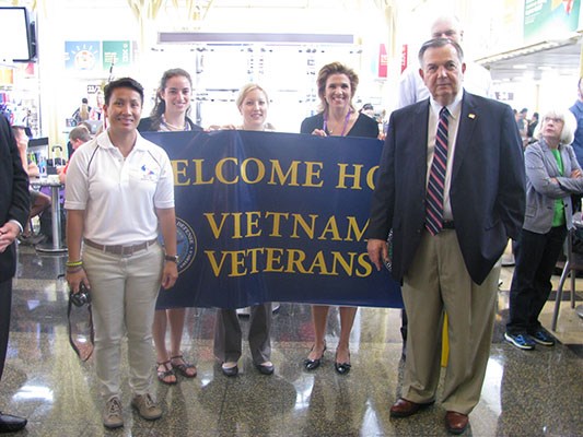 Greeters welcome visiting Vietnam Veterans arriving on an Honor Flight sponsored by Old Glory Honor 