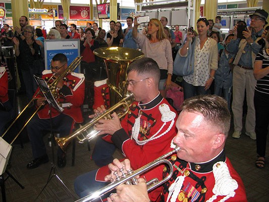 Travelers awaiting their flights gather to welcome Vietnam Veterans at Reagan National Airport in Wa