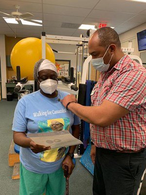 A Vietnam veteran receives her lapel pin.