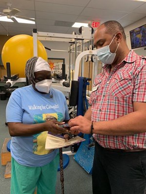 A Vietnam veteran receives her lapel pin.