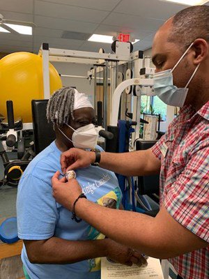 A Vietnam veteran receives her lapel pin.