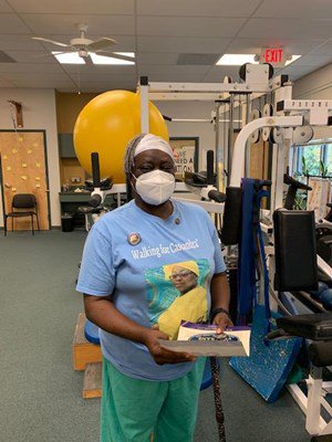 A Vietnam veteran receives her lapel pin.