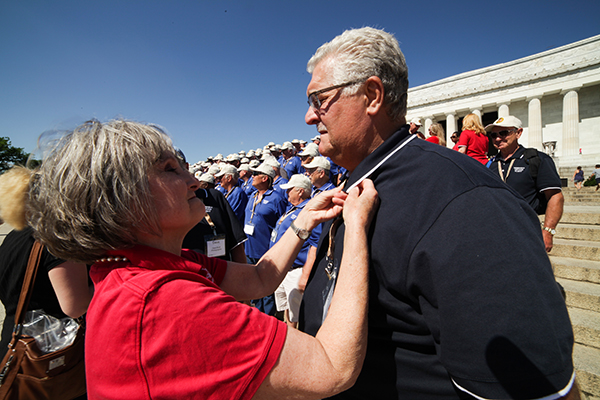 Ann Salley Crider presents a Vietnam Veteran Lapel pin to a veteran.