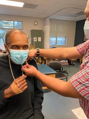 A Vietnam veteran receives his lapel pin.