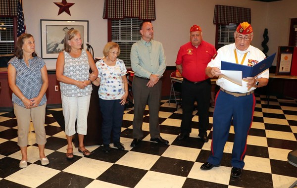 Chairman Lou Calleja presents five siblings of Marine Lance Corporal Edward Charles Statelman with I