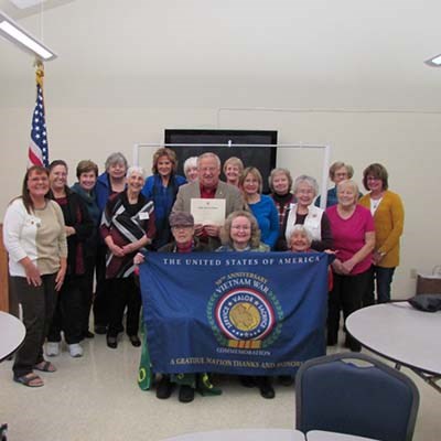 Champoeg Chapter NSDAR presents Army veteran Jim Peterson with a certificate of gratitude.