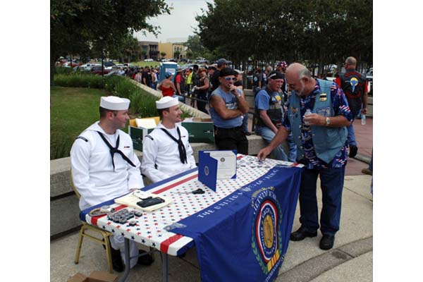 Navy servicemen distributed brochures and Vietnam pins for the Memorial Day ceremony