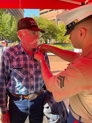 A Vietnam veteran is pinned during the 2023 Philadelphia Navy Week.