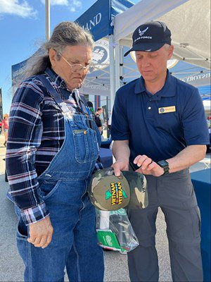 VWC&#39;s Henry Polczer spins a VVLP on the hat of a Vietnam veteran.