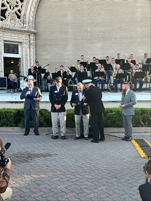 Photo of Cmdr. Brian Wierzbicki, USN, and Chief, Public Engagement, with VWC staff at a ceremony.