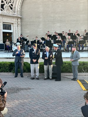 Photo of Cmdr. Brian Wierzbicki, USN, and Chief, Public Engagement, with VWC staff at a ceremony.