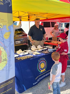 Photo on 11/4/23, at the Fleet Week Football Classic, of VWC staff manning the information booth. 