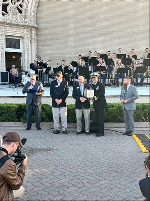 Photo of Cmdr. Brian Wierzbicki, USN, Chuck Crosby, Rich Lovelady and others prepare for a photo. 
