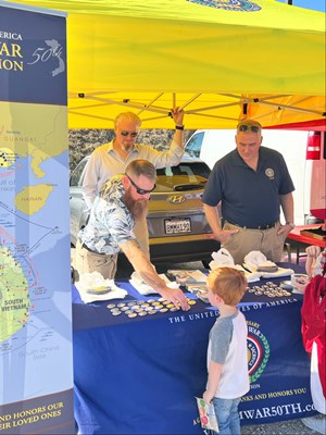 Photo on 11/4/23, at the Fleet Week Football Classic, of VWC staff manning the information booth. 