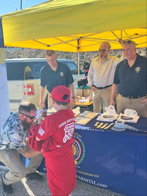 Photo on 11/4/23, at the Fleet Week Football Classic, of VWC staff manning the information booth. 