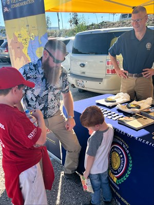 Photo on 11/4/23, at the Fleet Week Football Classic, of VWC staff manning the information booth. 