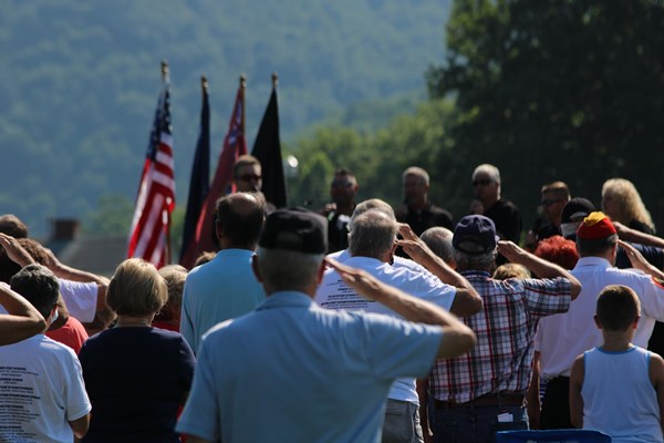 Veterans saluting during the opening ceremony