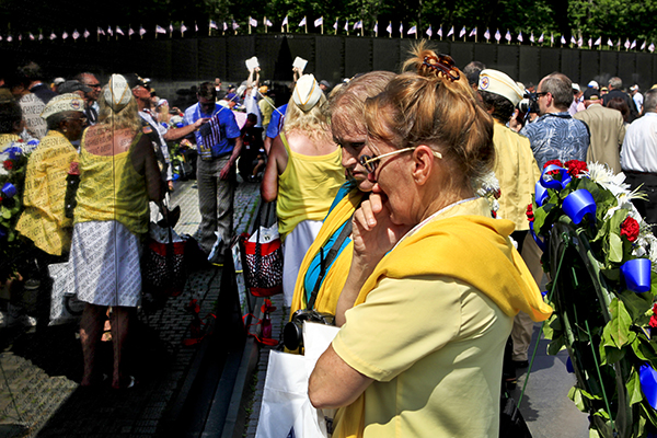 Kathy Cardona and her daughter, Julianna Blamire, both of Connecticut, hold back emotion as they loo