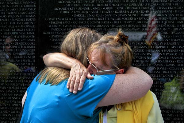 Kathy Cardona embraces her daughter, Julianna Blamire, both of Connecticut, after observing the name