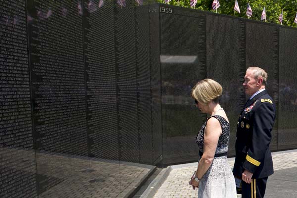 Chairman of the Joint Chiefs of Staff Gen. Martin E. Dempsey and his wife, Deanie, observe names on 