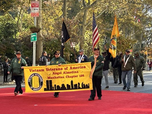  Parade participants marching along the route.