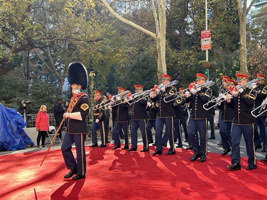 A military band plays along the route.