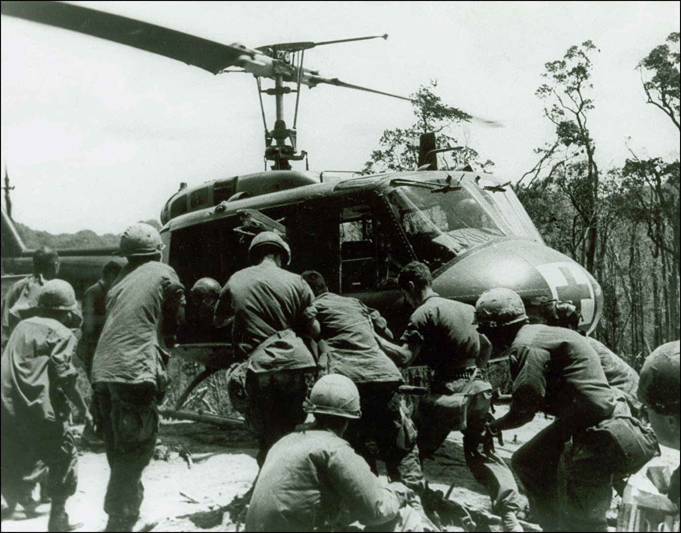 U.S. Army soldiers of the 101st Airborne load wounded servicemen into a medevac helicopter during Operation APACHE SNOW, May 1969