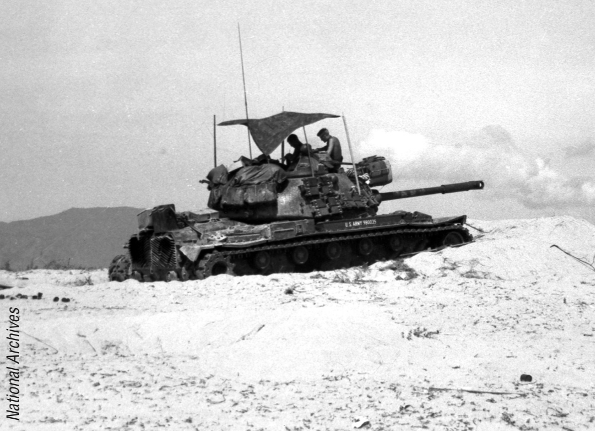 A tank and its crew attached to the 34th Armor Regiment, Task Force OREGON, near Duc Pho, June 1967. (National Archives)