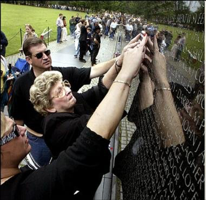 McGriff’s widow, Anna McGriff, touches her husband’s name on the Vietnam Veterans Memorial after it was etched in 2003. (VVMF)