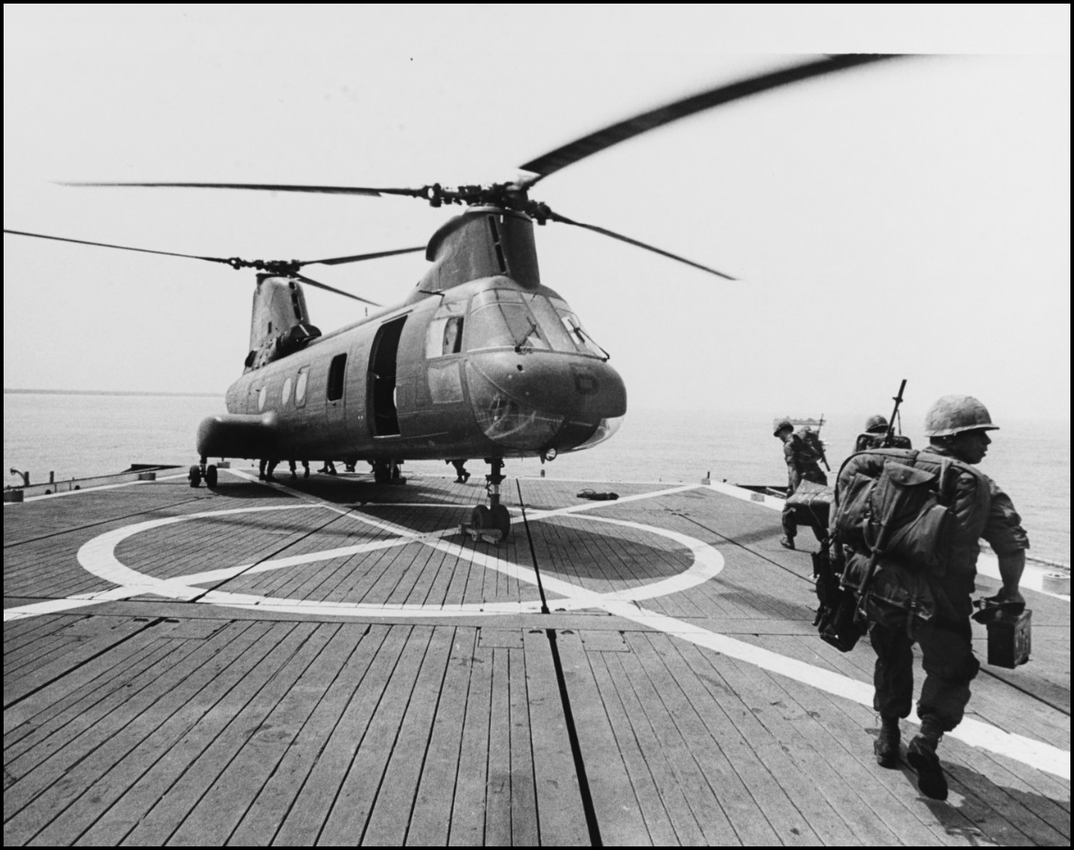 U.S. Marines preparing to board a CH-46 Sea Knight helicoptor on the deck of the USS Monticello (LSD-35), March 21, 1967.