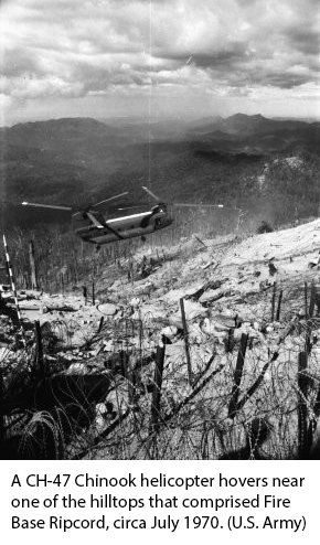 A CH-47 Chinook helicopter hovers near one of the hilltops that comprised Fire Base Ripcord, circa July 1970. (U.S. Army)